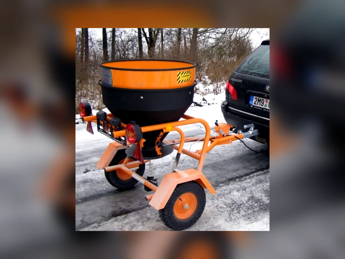 Fuji towable salt spreader in a snowy yard