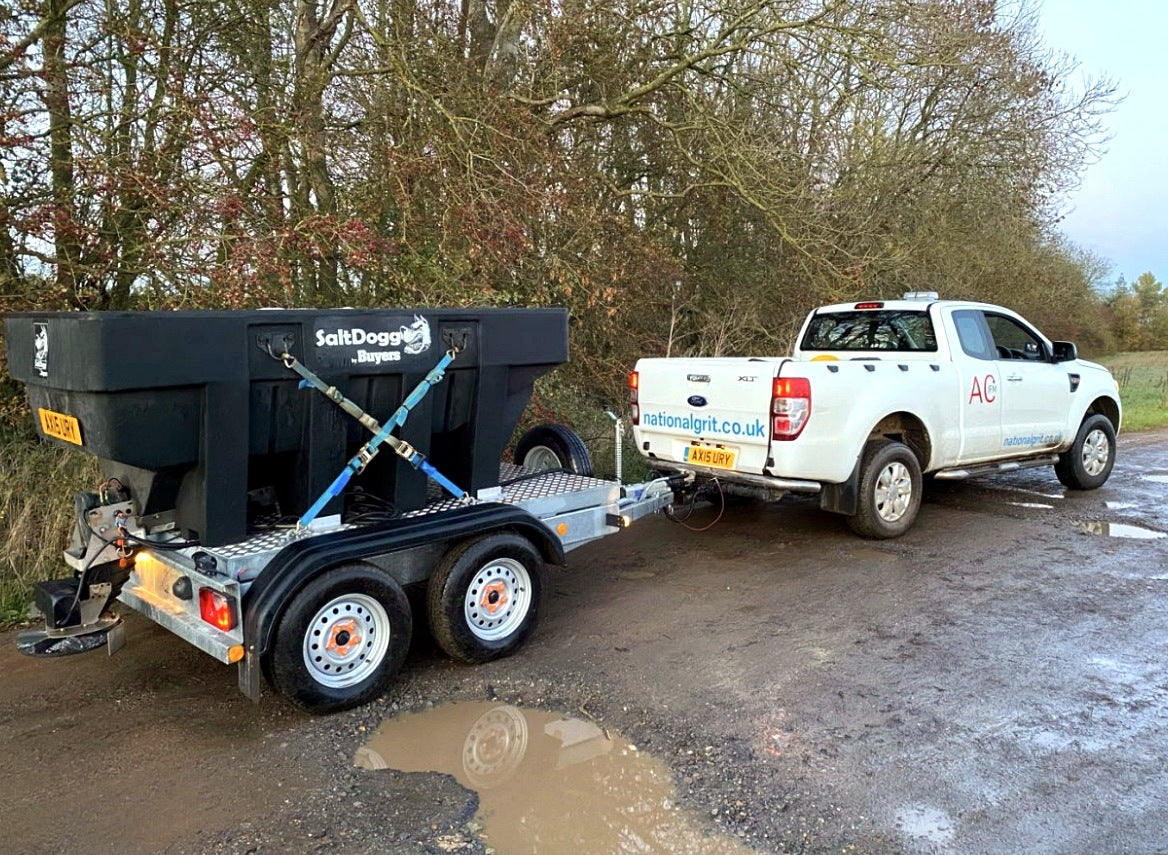 SaltDogg SHPE2000 1600L hopper salt spreader mounted on a tandem-axle trailer
